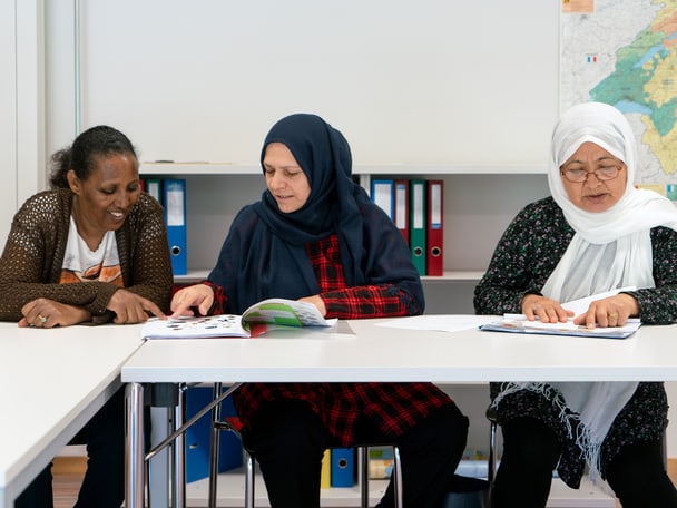 Frauen sitzen am Tisch und lernen. 