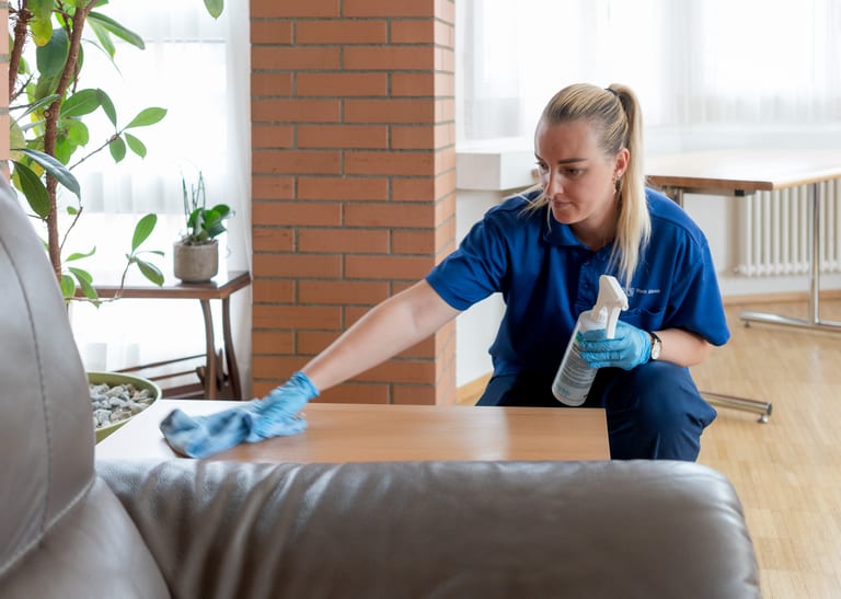 Eine Frau reinigt eine Oberfläche.